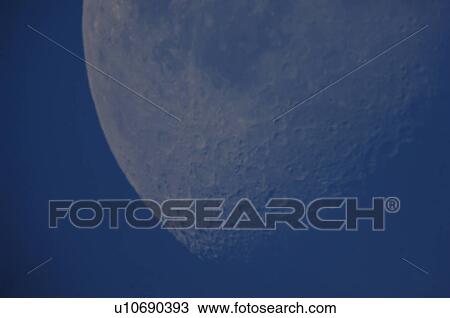 Stock Image - The moon in the sky over Lake of the Woods. Fotosearch