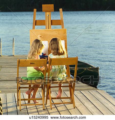 Stock Photography - Children sitting at an easel. Fotosearch