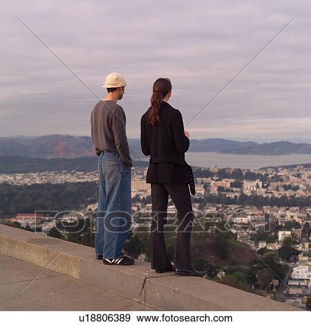 Stock Photo - Man and Woman taking in Aerial View of San Francisco. Fotosearch