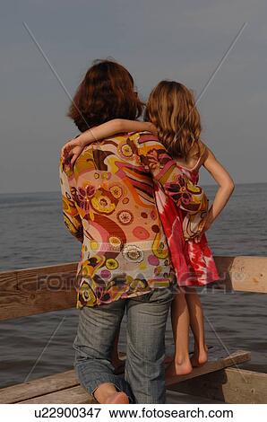 Stock Photo - Mother daughter looking at the water. Fotosearch