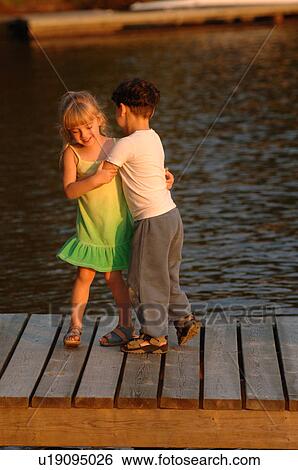 Stock Photograph - Two children dancing outdoors. Fotosearch