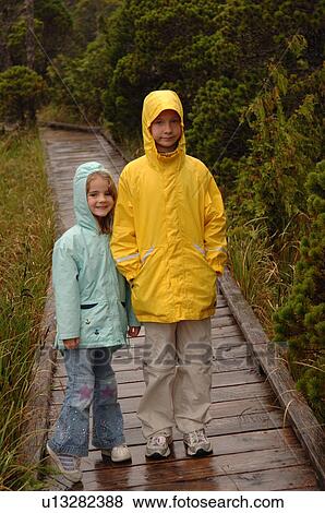 Two children standing on path in forest View Large Photo Image Stock Photo - Two children standing on path in forest. Fotosearch