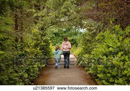 Stock Photo - Two children walking along path in forest. Fotosearch