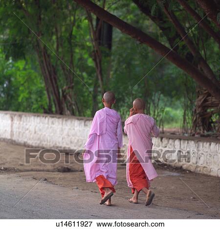 Stock Photo - Two Monks walking on road. Fotosearch
