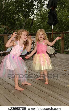 Stock Photograph - Two young girls dancing in fairy costumes. Fotosearch