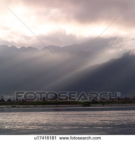 Stock Image - Dark skies over Inle Lake. Fotosearch