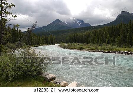 Stock Image - River flowing in a valley, Rocky Mountains, Canada. Fotosearch