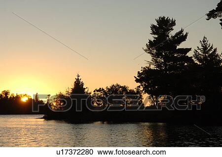 Silhouette of shoreline against twilight sky View Large Photo Image Stock Image - Silhouette of shoreline against twilight sky. Fotosearch