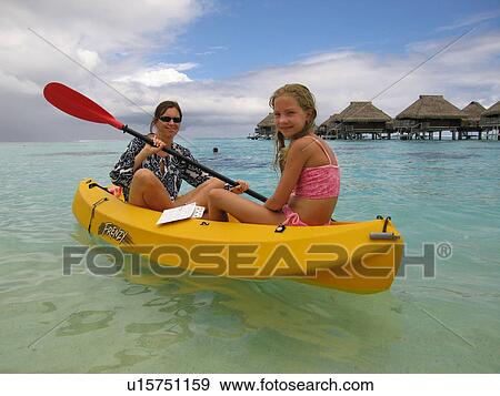 A young woman sitting in a boat with a young girl View Large Photo Image Stock Photo - A young woman sitting in a boat with a young girl. Fotosearch