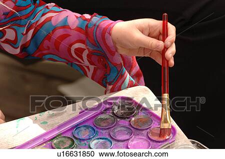 Artist dipping brush in paint View Large Photo Image Stock Image - Artist dipping brush in paint. Fotosearch