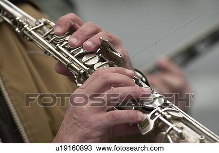 Male musician playing a clarinet View Large Photo Image Stock Image - Male musician playing a clarinet. Fotosearch