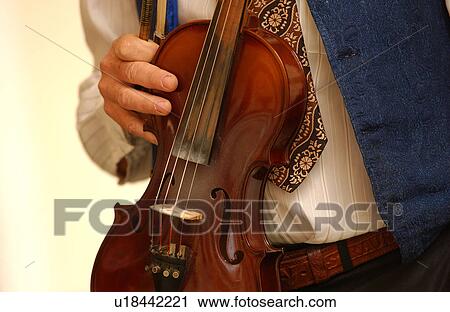 Person holding a violin View Large Photo Image Stock Image - Person holding a violin. Fotosearch