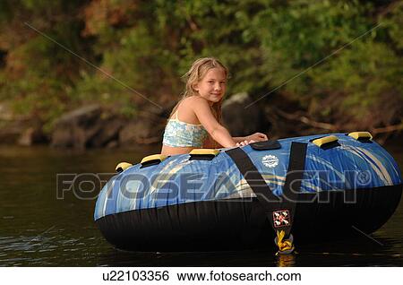 Teenager floating on a raft View Large Photo Image Stock Photograph - Teenager floating on a raft. Fotosearch