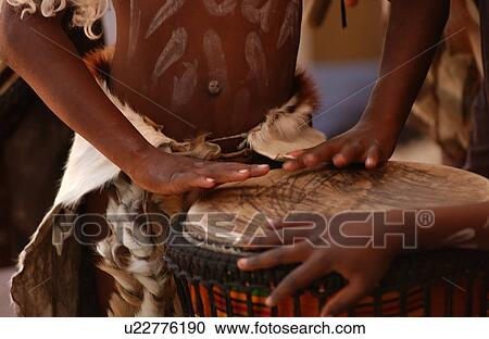 Stock Image - Traditional Tribe Playing Drum. Fotosearch