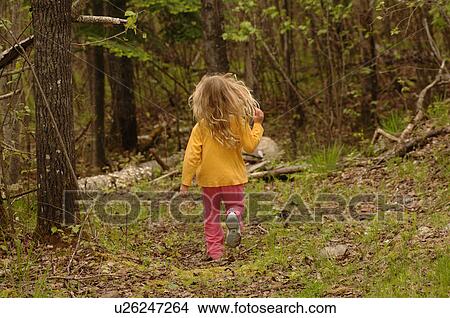 Picture - Back of small child running through forest. Fotosearch