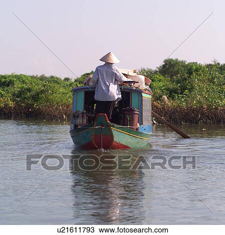 Stock Image - Boat with on the lake in Cambodia. Fotosearch