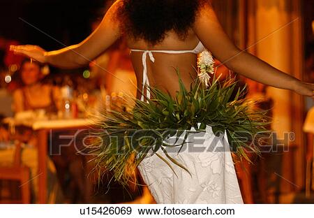 Stock Photo - Close-up of a young woman wearing a grass belt dancing. Fotosearch