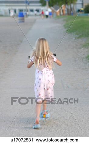 Stock Image - Girl Playing on Scooter. Fotosearch