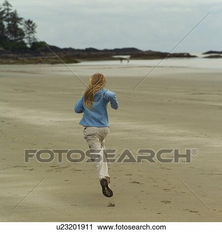 Stock Image - Girl running on beach. Fotosearch