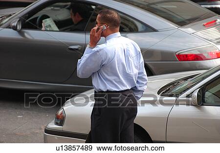 Stock Photo - Man talking on cell phone. Fotosearch