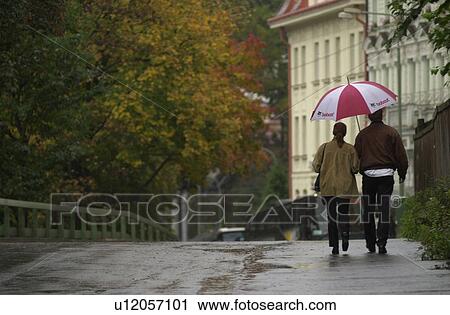 Rear view of a couple walking together in Prague View Large Photo Image Stock Image - Rear view of a couple walking together in Prague. Fotosearch