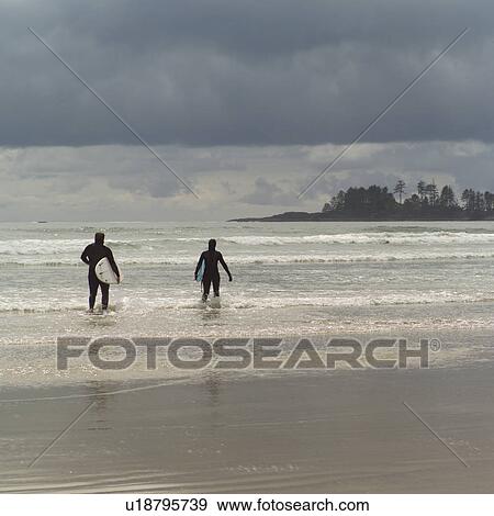 Surfers with surfboards on beach View Large Photo Image Stock Photo - Surfers with surfboards on beach. Fotosearch