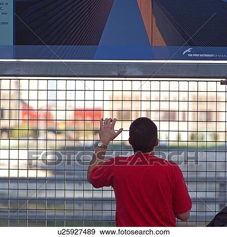 Tourist at the barrier surrounding the World Trade Center site, New York City View Large Photo Image Stock Photo - Tourist at the barrier surrounding the World Trade Center site, New York City. Fotosearch
