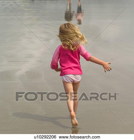Stock Photograph - Young blond girl running on beach. Fotosearch