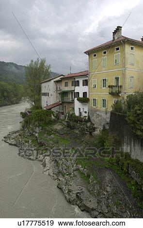 Stock Photo - Houses by a river in Slovenia. Fotosearch