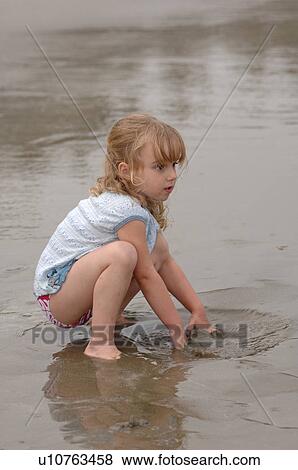 3 Year old playing in water on beach View Large Photo Image Stock Photo - 3 Year old playing in water on beach. Fotosearch