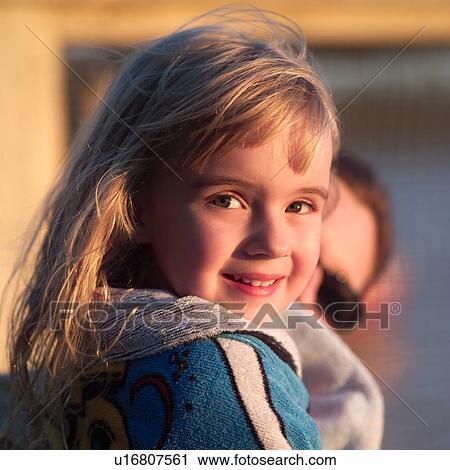 Stock Image - 4 year old blond girl looking at camera. Fotosearch