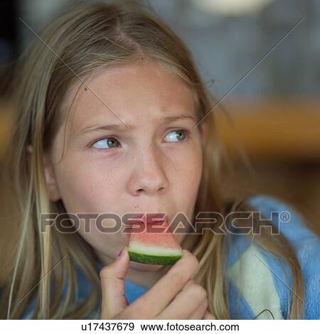 Blond girl eating watermelon View Large Photo Image Stock Photo - Blond girl eating watermelon. Fotosearch