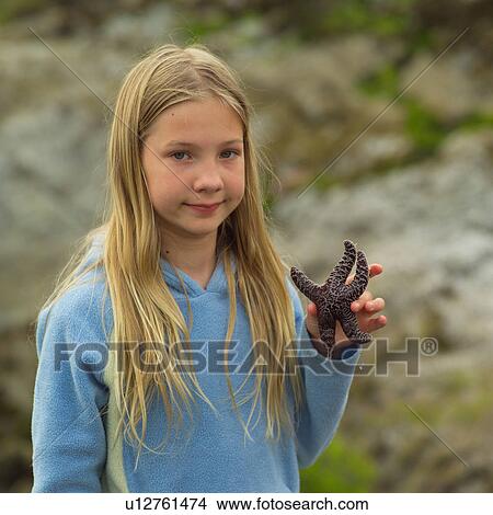Blond Girl holding a Starfish View Large Photo Image Picture - Blond Girl holding a Starfish. Fotosearch