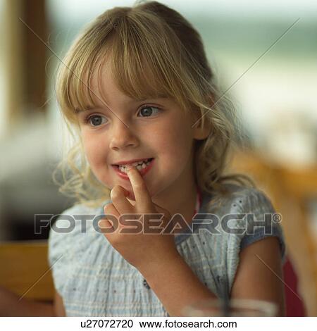 Blond girl with her finger in her mouth View Large Photo Image Stock Image - Blond girl with her finger in her mouth. Fotosearch
