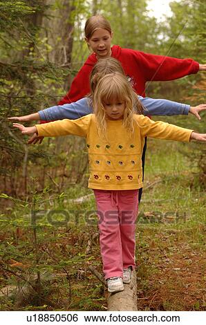 Stock Photograph - Children balancing on a log. Fotosearch