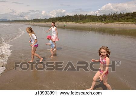 Stock Image - Children on beach, Pacific Rim National Park, Vancouver Island, Canada. Fotosearch