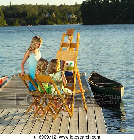 Children sitting at an easel View Large Photo Image Stock Image - Children sitting at an easel. Fotosearch