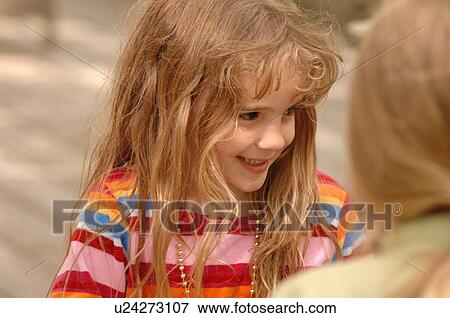 Stock Photo - Close up of blond girl’s face. Fotosearch