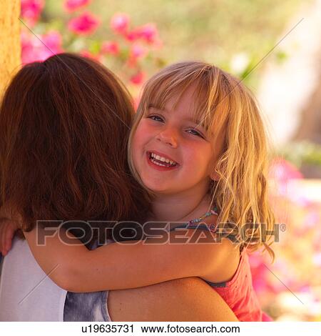 Stock Image - Mother cuddling with her daugher. Fotosearch