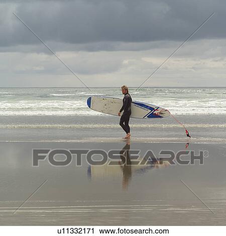 Surfer with surfboard on beach, Pacific Rim Park, Vancouver Island, Canada View Large Photo Image Stock Image - Surfer with surfboard on beach, Pacific Rim Park, Vancouver Island, Canada. Fotosearch