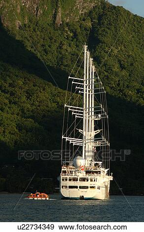 A luxury yacht with white sails in the sea View Large Photo Image Stock Photo - A luxury yacht with white sails in the sea. Fotosearch