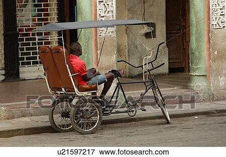 A man sitting in a Pedicab View Large Photo Image Stock Photo - A man sitting in a Pedicab. Fotosearch