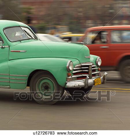 Stock Image - Antique cars on a road. Fotosearch