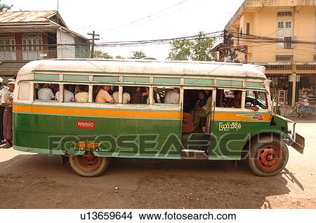 Picture - Green bus full of people in Myanmar. Fotosearch