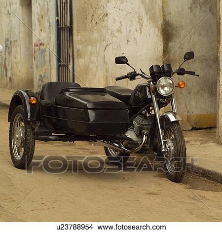 Motorcycle with a sidecar parked in an alleyway View Large Photo Image Picture - Motorcycle with a sidecar parked in an alleyway. Fotosearch