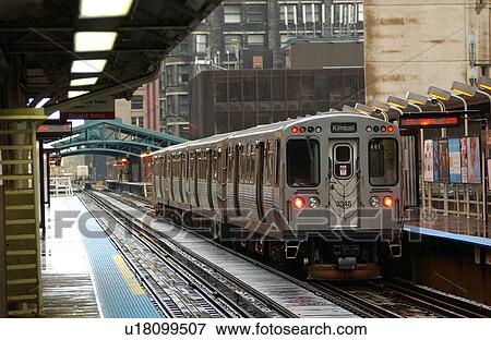 Stock Photo - Train moving on the tracks at CTA Station in Chicago. Fotosearch