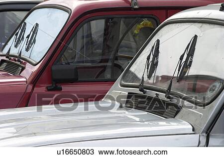 Stock Image - Two cars parked in Slovenia. Fotosearch