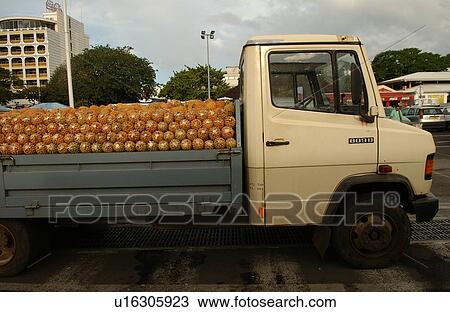 Stock Image - A truck loaded with pineapples, Papeete, Tahiti, French Polynesia, South Pacific. Fotosearch