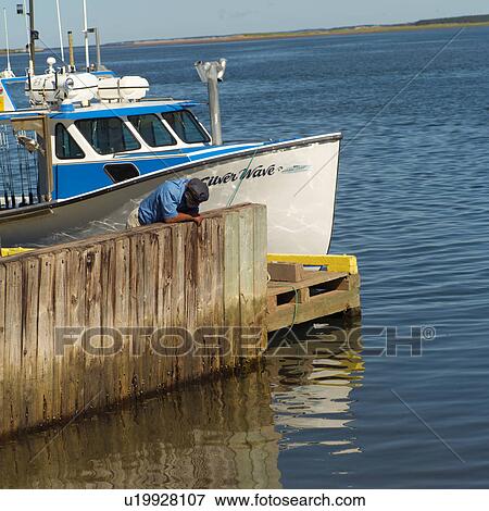 Stock Photo - Fishing boat docked at a harbor in Prince Edward Island, Canada. Fotosearch