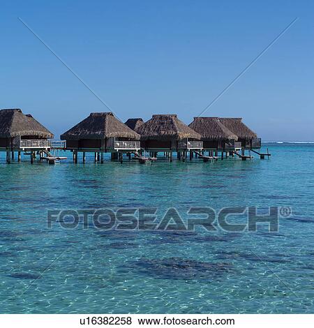 Stock Photo - Huts over Ocean at Moorea in Tahiti. Fotosearch